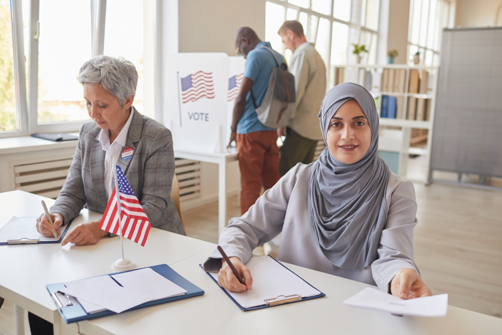 Two women sitting at a table doing paperwork